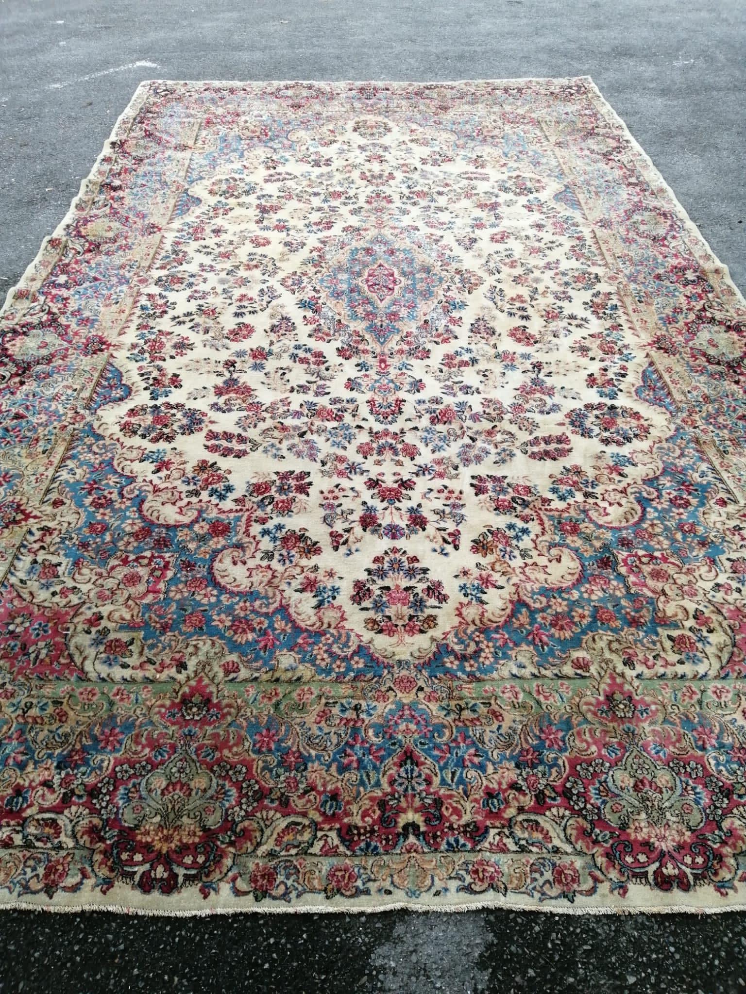 A large Tabriz ivory ground floral carpet, 500 x 300cm